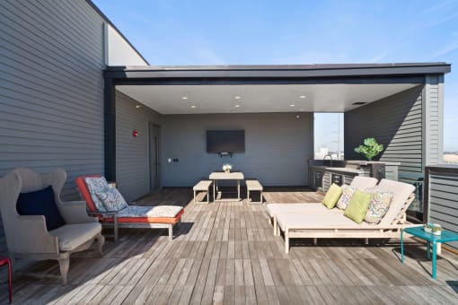 a patio with furniture and a tv on the wall
