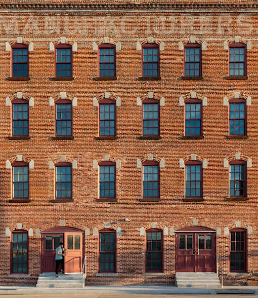 A red brick building with a sign that says