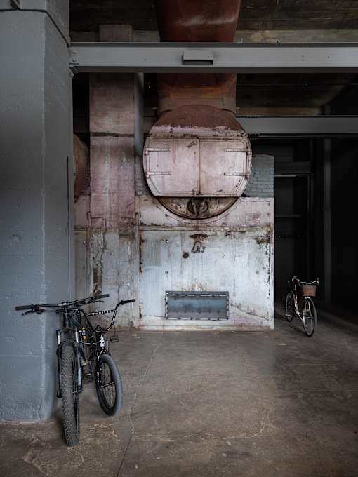 A bicycle is parked in a dimly lit garage.