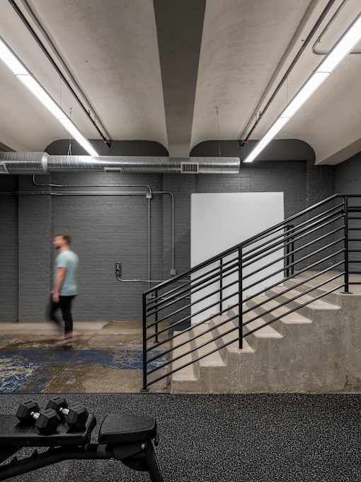 A man is walking up a staircase in a modern building.