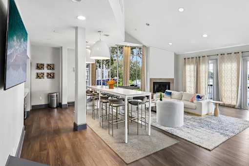 A modern living room with a white sofa and a fireplace.