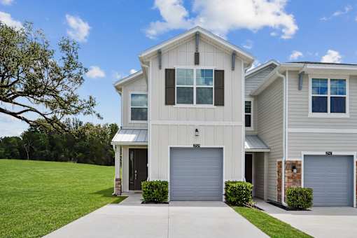 A modern two-story house with a garage on the ground floor.