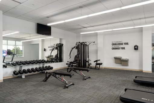 a gym with weights and other exercise equipment in the corner of a room at Verge Apartments in St. Louis Park, MN