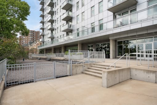 the entrance to an apartment building with stairs and a ramp at Verge Apartments in St. Louis Park, MN