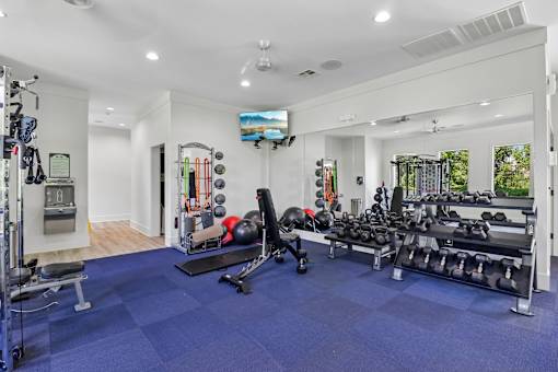 A spacious home gym with a variety of equipment.