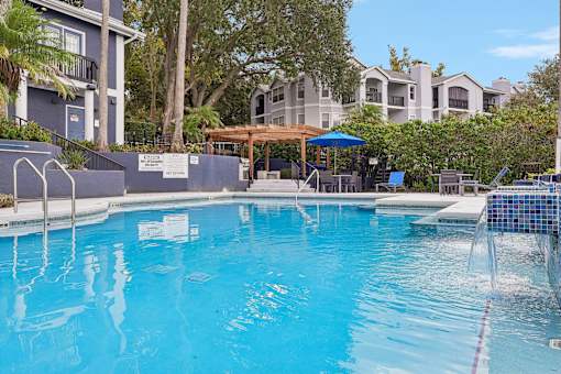 A swimming pool with a blue tiled edge and a white sign on the side.