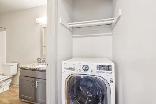 A white washing machine in a laundry room.