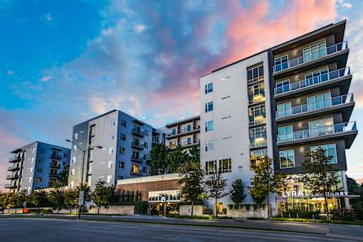 A modern apartment building with a street in front.