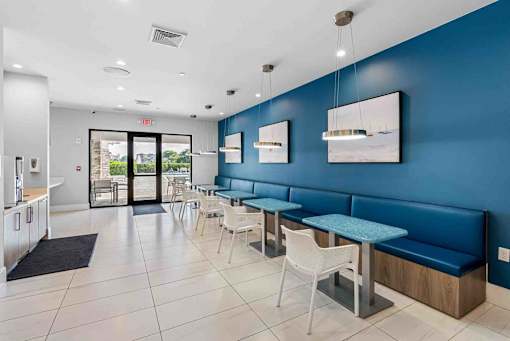 a restaurant with blue walls and tables and chairs