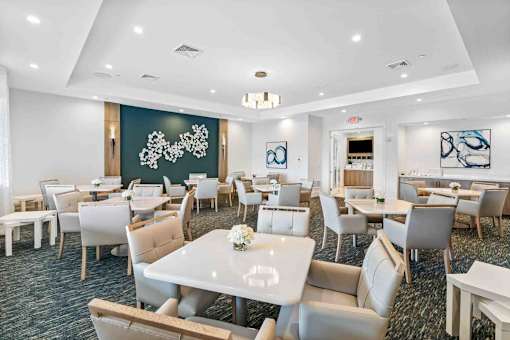 a dining room with tables and chairs and a large chalkboard in a conference room
