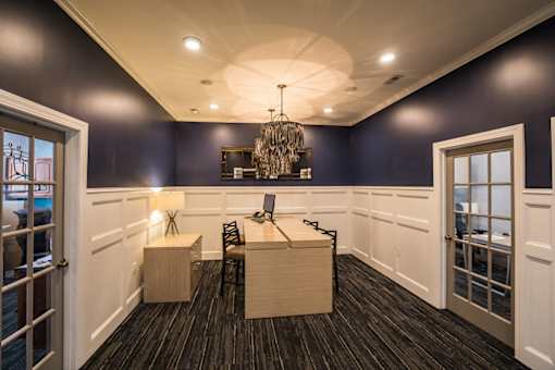 A room with a desk and a chair in it.