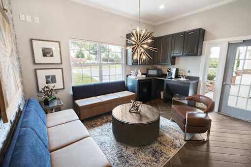 A modern living room with a large sectional sofa and a coffee table.