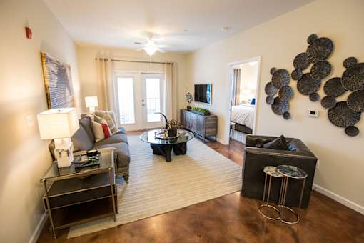A living room with a couch, chair, and coffee table.
