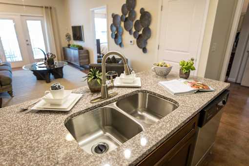 A kitchen with a granite countertop and a sink.