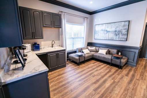 A kitchen with dark wood cabinets and a white countertop.