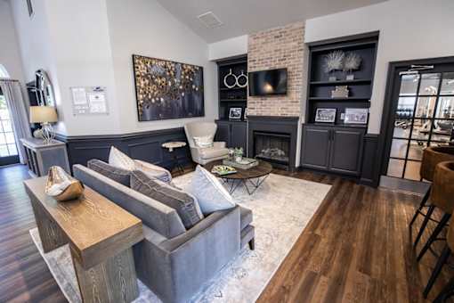 A living room with a grey couch and a wooden coffee table.