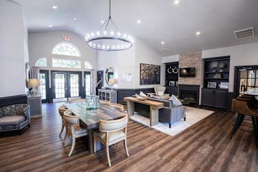 A modern dining room with a glass table and chairs.