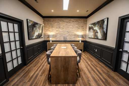 A conference room with a long table and chairs.
