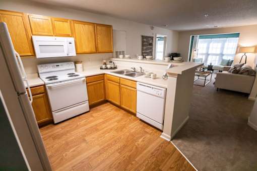 A kitchen with wooden cabinets and white appliances.