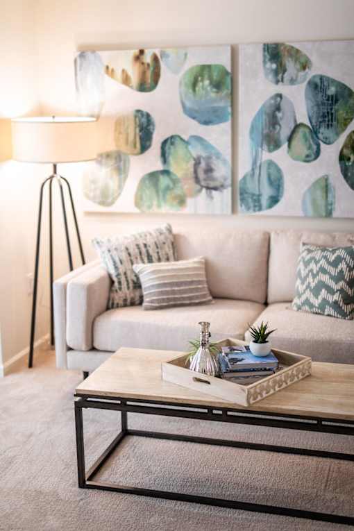 A living room with a white couch and a coffee table.