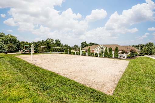 A soccer field with a goal in the middle of a grassy area.
