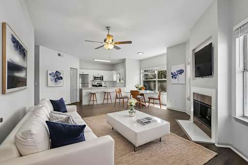 A living room with a white couch and a coffee table.