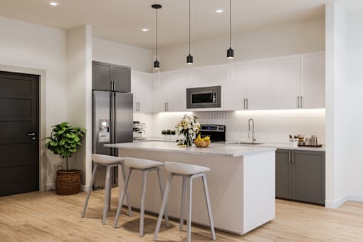 A modern kitchen with a white island and stools.
