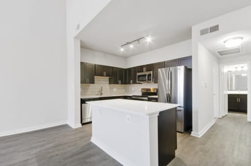 Newly Renovated Apartments and Townhomes with Custom Espresso Cabinetry, Gourmet Kitchen Islands, White Marble or Grey Quartz Countertops, and Wood Style Flooring
