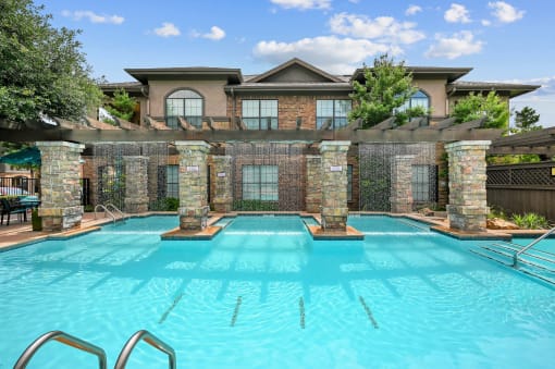 a swimming pool with a house in the background