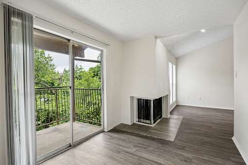 A modern living room with a fireplace and sliding glass doors.