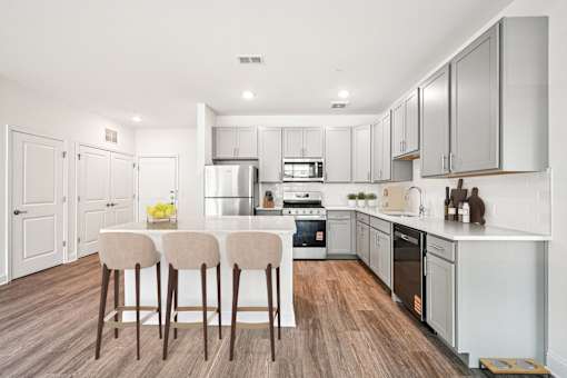 Mt. Laurel Township, NJ, Garden-Style Apartments Near Rowan College at Burlington County - Laurel Green - Kitchen with Stainless Steel Appliances, Maple Cabinets, Granite Countertops, and Island.