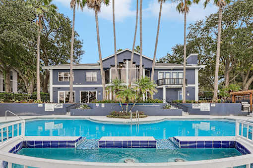 A house with a pool in front of it.