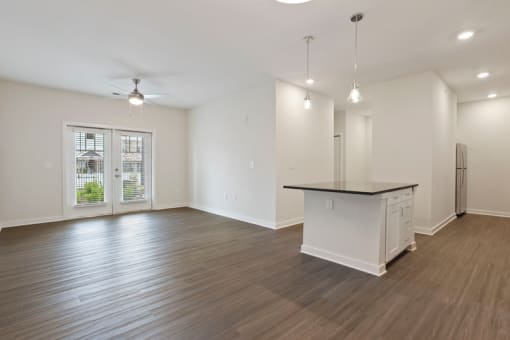 the living room and kitchen of an empty house