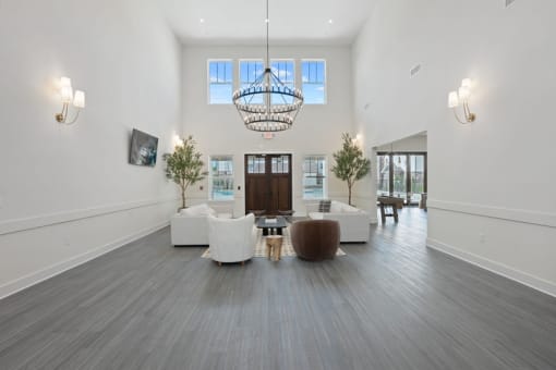 a living room with couches and chairs and a chandelier