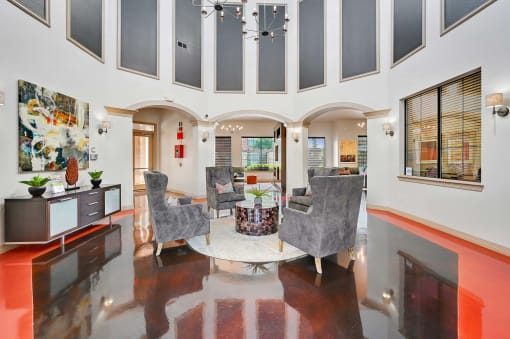 a living room with high ceilings and a table with chairs