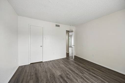 A room with a white door and a white wall.