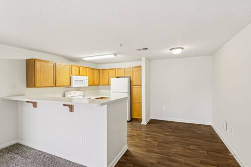 A kitchen with white cabinets and a white counter top.