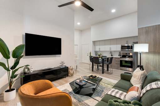 A modern living room with a flat screen TV mounted on the wall.