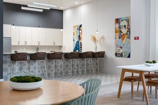 A modern kitchen with a dining table and chairs.