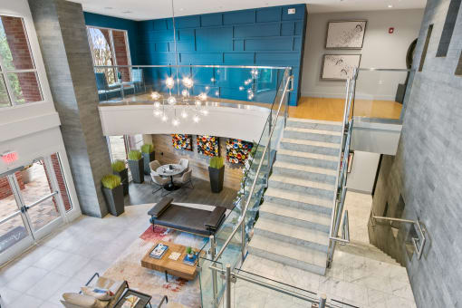 a view of the lobby of a building with stairs and a blue wall