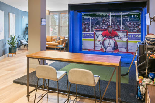 a dining room with a table and chairs and a large screen tv