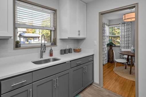 A kitchen with a sink and cabinets.