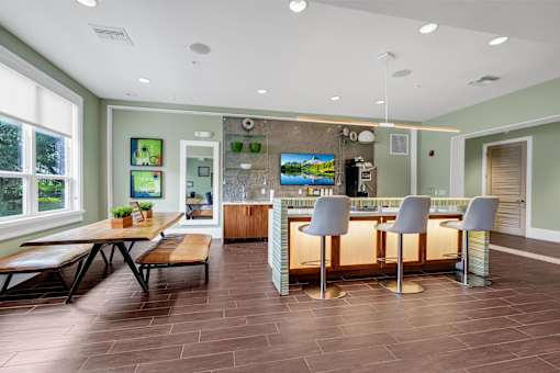 A modern kitchen with a bar area and a dining table.