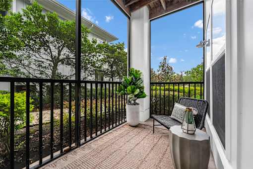 A balcony with a black railing and a bench.