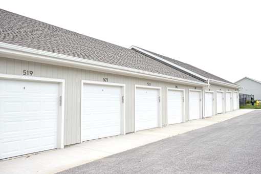 A long row of white garage doors with numbers 519, 521, 523, 525, 527, 529, 531, 533,