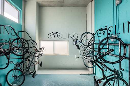 A room full of bicycles with a sign that says cycling.