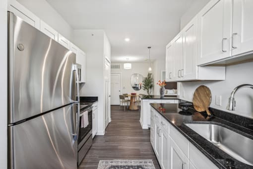 a kitchen with stainless steel appliances and white cabinets