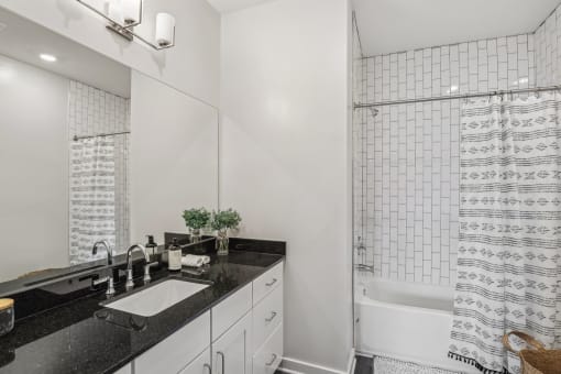 a white bathroom with a sink and a shower