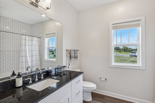 a white bathroom with a sink and a toilet