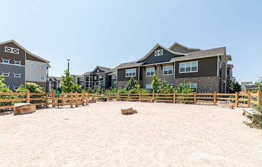 A sandy area in front of a row of houses.